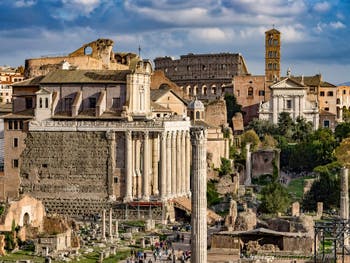 The Roman Forum with the Antoninus and Faustina Temple and the Colosseum in the background, in Rome in Italy