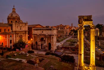 Roman Forum by night, Septimius Severus Triumphal Arch and Concord Temple three columns in Rome in Italy